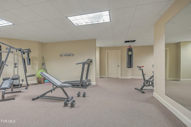 exercise room with a drop ceiling and carpet