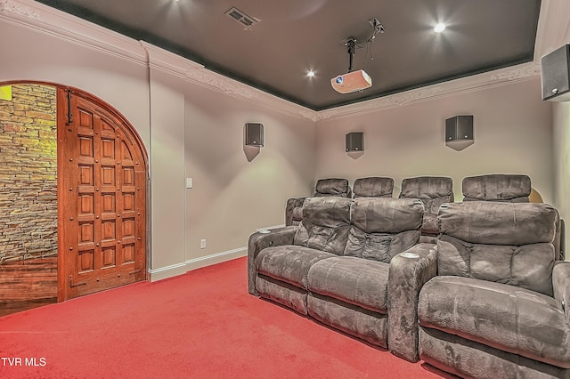 home theater with carpet floors and crown molding