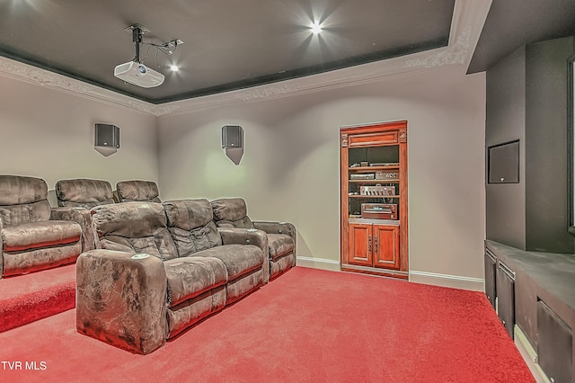 carpeted home theater featuring a raised ceiling and crown molding