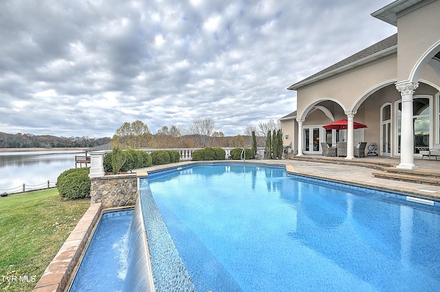 view of swimming pool featuring a water view and french doors