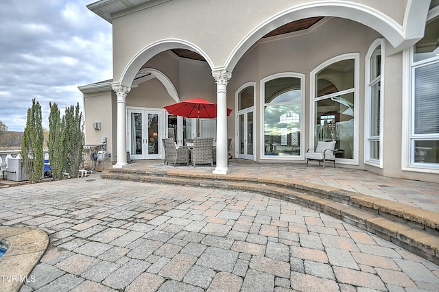 view of exterior entry featuring a patio and french doors