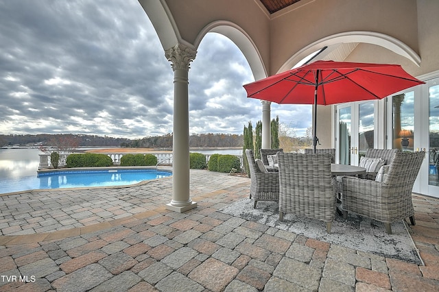 view of patio / terrace featuring french doors and a water view