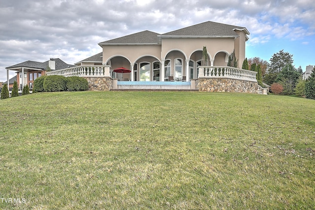 rear view of house featuring a yard