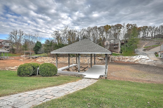 surrounding community with a gazebo and a yard