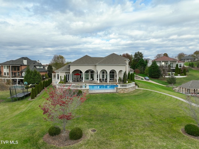 rear view of property featuring a yard and a patio