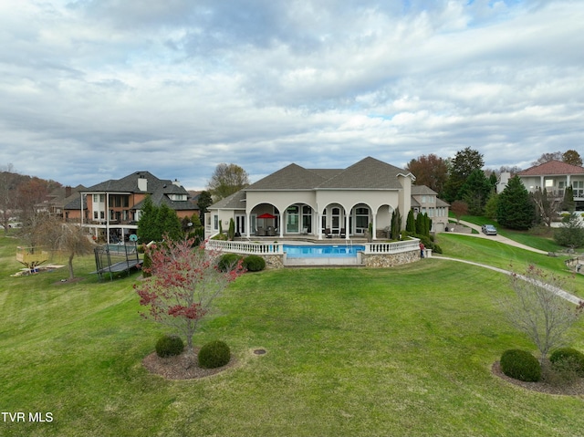 rear view of house featuring a yard and a patio area