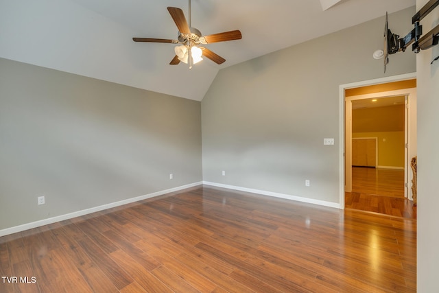 empty room featuring hardwood / wood-style flooring, ceiling fan, and lofted ceiling