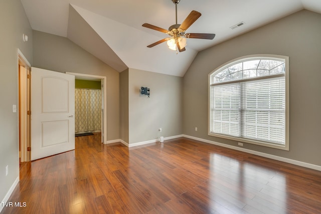 unfurnished room featuring vaulted ceiling, dark wood-type flooring, and ceiling fan