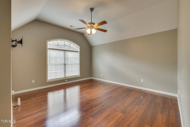 unfurnished room with lofted ceiling, dark wood-type flooring, and ceiling fan