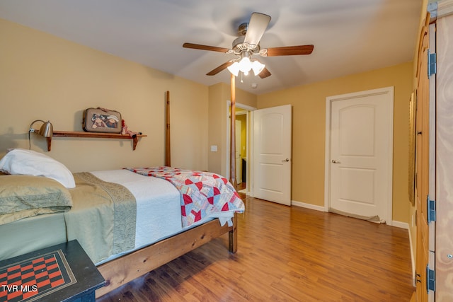 bedroom with hardwood / wood-style flooring and ceiling fan