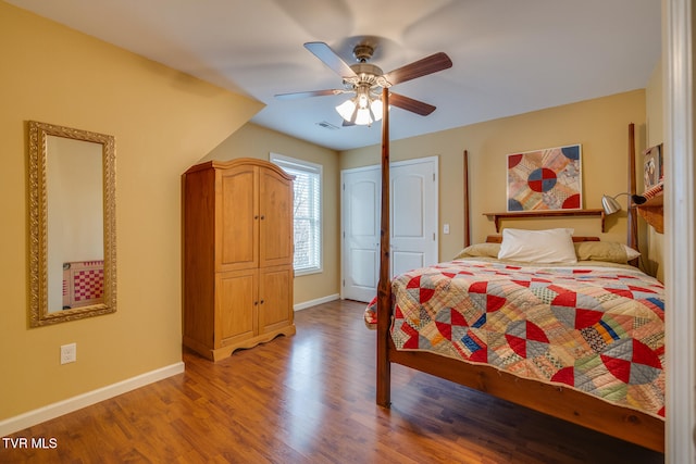 bedroom with ceiling fan, wood-type flooring, and a closet