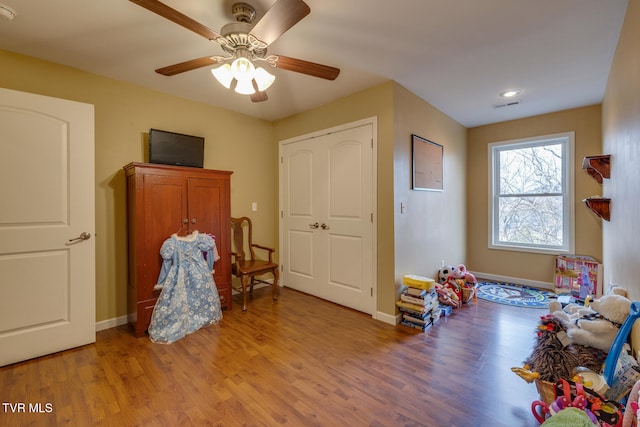 rec room with hardwood / wood-style flooring and ceiling fan