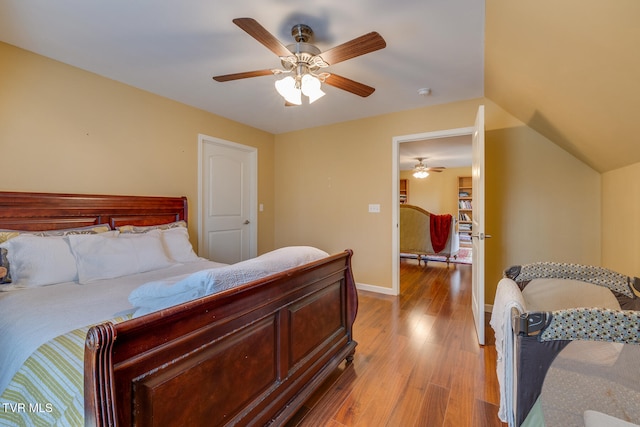 bedroom featuring vaulted ceiling, light hardwood / wood-style floors, and ceiling fan