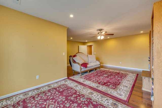 sitting room with hardwood / wood-style flooring and ceiling fan