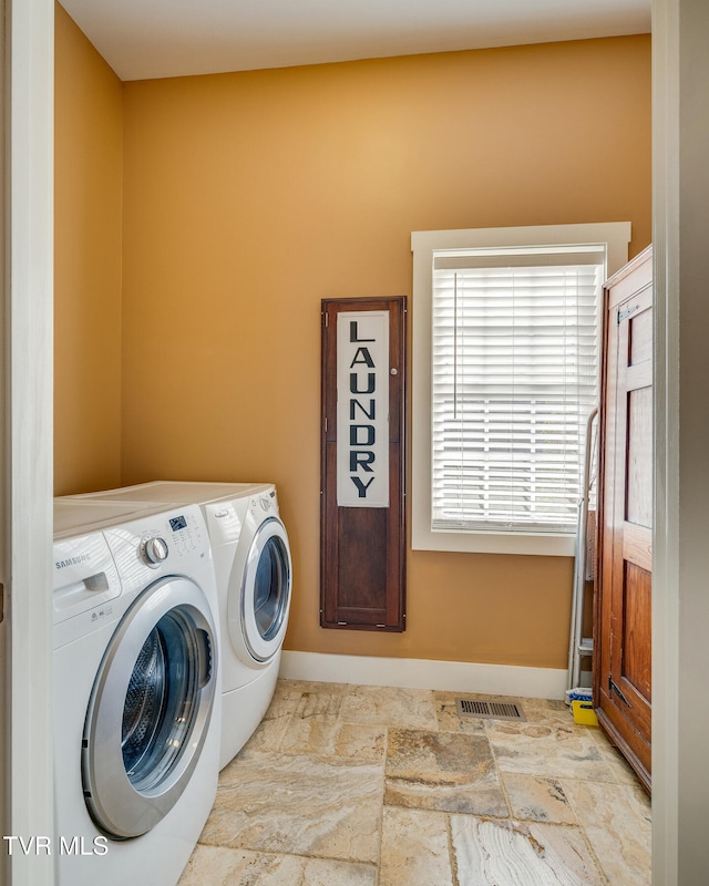 clothes washing area with washer and dryer