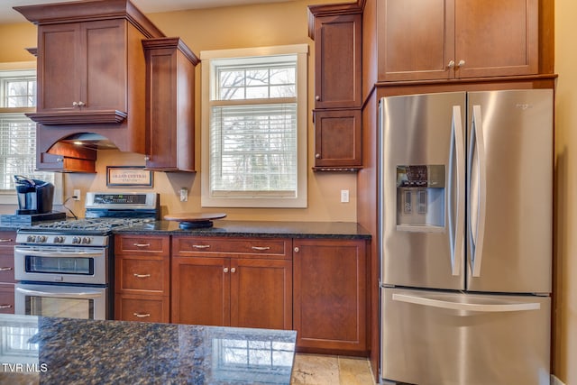 kitchen featuring dark stone countertops and appliances with stainless steel finishes