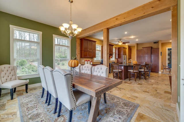 dining room featuring beamed ceiling and ceiling fan with notable chandelier