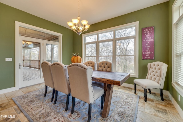 dining room featuring a healthy amount of sunlight and a chandelier