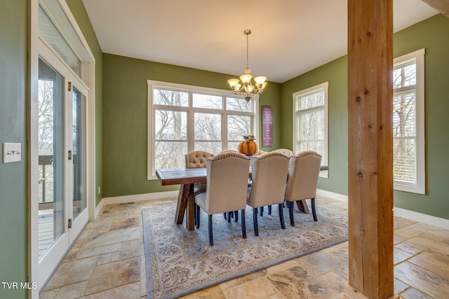 dining space with an inviting chandelier