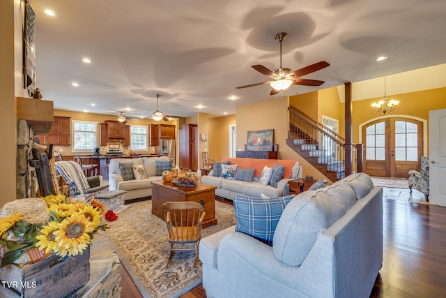 living room featuring french doors, dark hardwood / wood-style flooring, and ceiling fan with notable chandelier