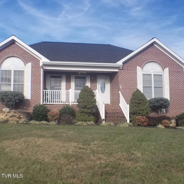 ranch-style house with a front lawn and covered porch