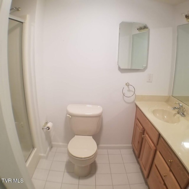 bathroom with tile patterned flooring, vanity, and toilet