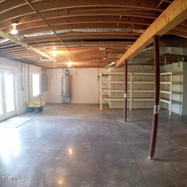 basement featuring gas water heater and electric panel