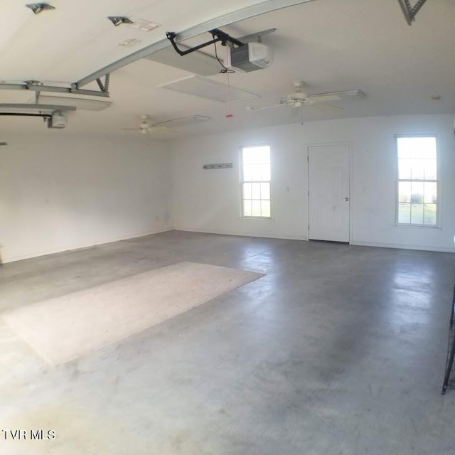 garage with ceiling fan and a garage door opener