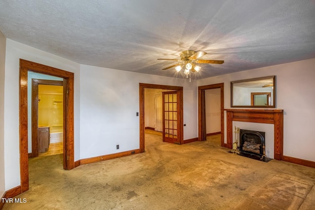 unfurnished living room with carpet flooring, a textured ceiling, and ceiling fan