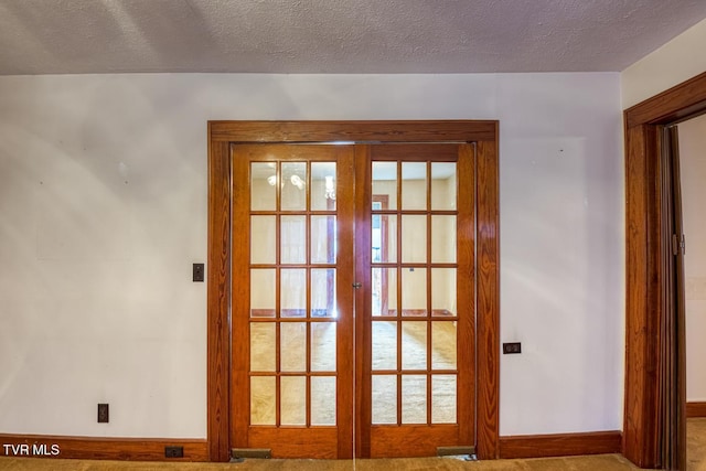 doorway to outside with carpet flooring, a wealth of natural light, french doors, and a textured ceiling