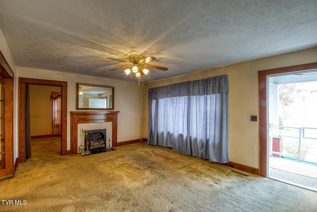 unfurnished living room featuring carpet, a textured ceiling, and ceiling fan