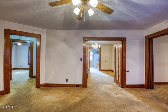 interior space with light colored carpet, a textured ceiling, and french doors