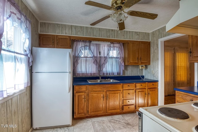 kitchen with a textured ceiling, ceiling fan, white appliances, and sink