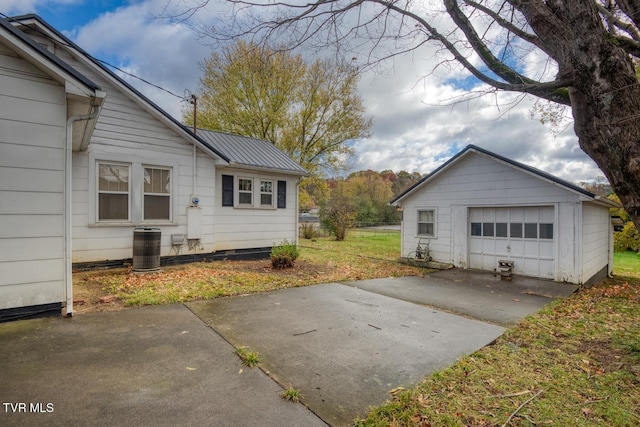 garage featuring a yard and cooling unit