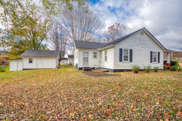 rear view of property featuring a yard