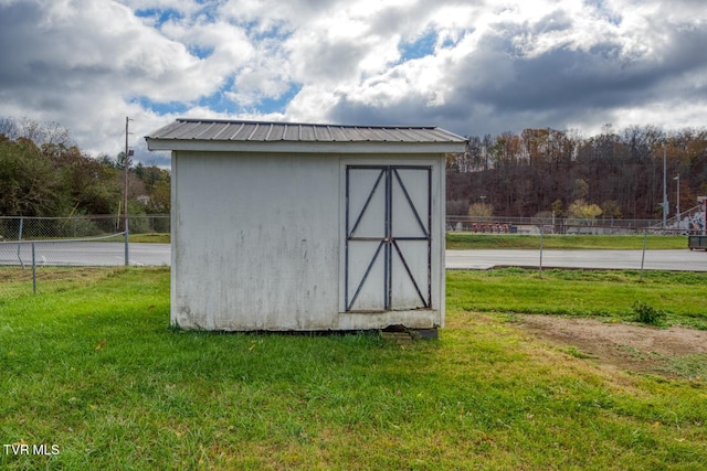 view of outbuilding with a lawn