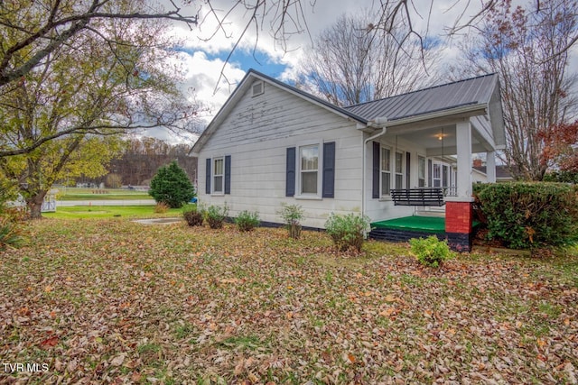 view of side of home with covered porch