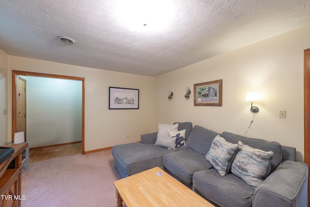 carpeted living room with a textured ceiling