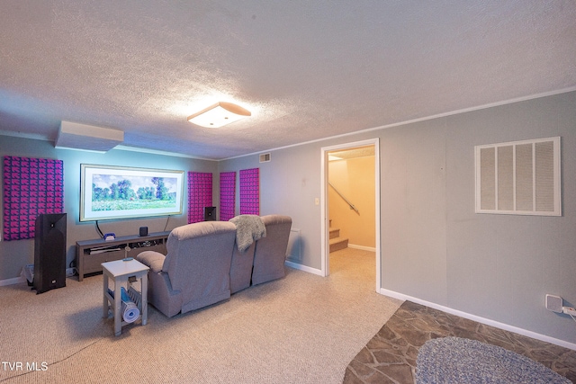 carpeted cinema featuring crown molding and a textured ceiling