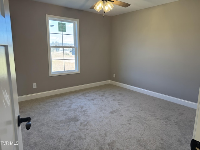 carpeted empty room featuring ceiling fan