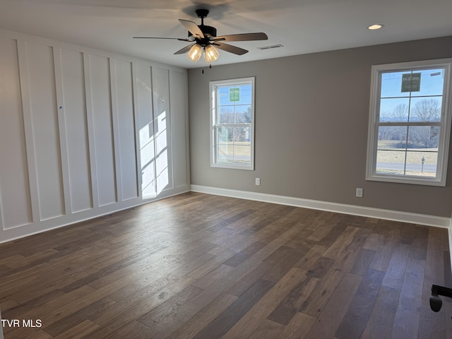 empty room with dark hardwood / wood-style floors and ceiling fan