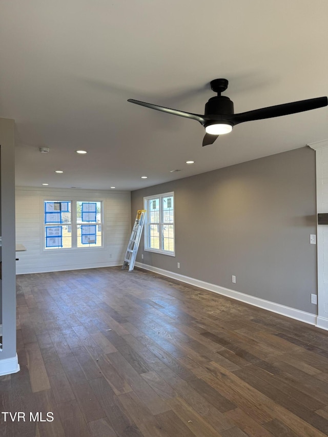 empty room featuring dark wood-type flooring and ceiling fan