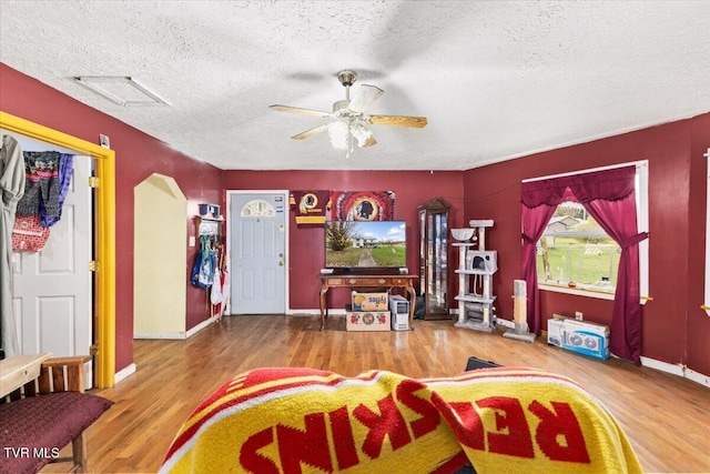 104 Maple St, Glade Spring, VA 24340 - living area featuring a textured ceiling, ceiling fan, wood finished floors, and baseboards