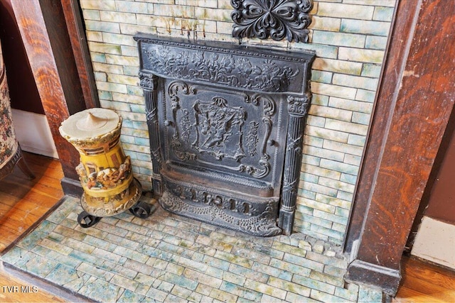 details featuring wood-type flooring and a wood stove