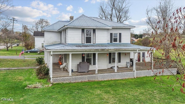 farmhouse-style home featuring covered porch and a front yard