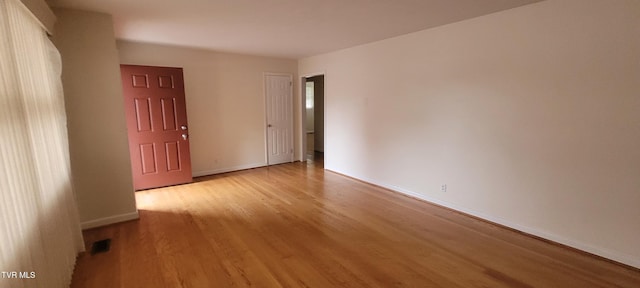 unfurnished room featuring light hardwood / wood-style floors