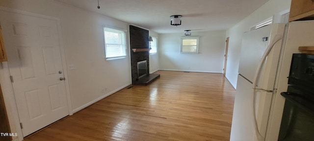 unfurnished living room with light hardwood / wood-style flooring