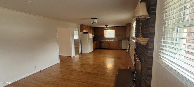 interior space with plenty of natural light, white fridge, and dark hardwood / wood-style flooring