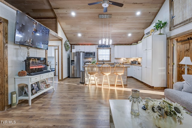 living room with ceiling fan, high vaulted ceiling, wooden ceiling, and hardwood / wood-style flooring