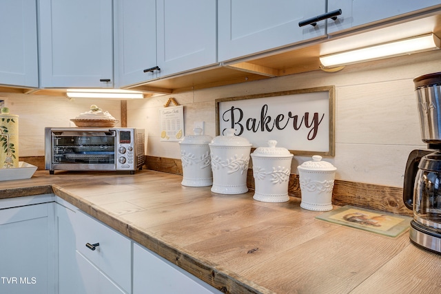 kitchen with tile counters and blue cabinetry